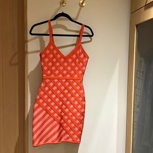 Orange fitted dress.